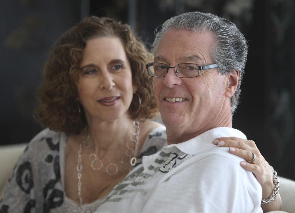 In this Sunday, July 8, 2012 photo, Jason and Karin Marder pose for a picture in their home in New York. Jason Marder, who turned 70 on Tuesday, July 10, 2012, was diagnosed with Alzheimer's more than eight years ago. In the roughly five years that her husband has taken Gammagard, "there has been decline" in his health but it is very minimal and the kind of slowing down you might expect from ordinary aging, she said. "He travels the subways, he does things that you and I do. And our quality of life together is what's most important." (AP Photo/Seth Wenig)