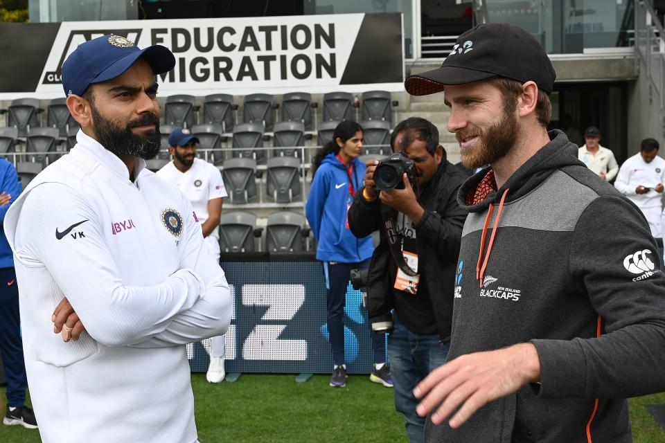 New Zealand captain Kane Williamson (R) talks to India captain Virat Kohli.