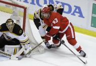 Boston Bruins goalie Tuukka Rask (40) of Finland stops a shot by Detroit Red Wings center Darren Helm (43) during the second period of Game 4 of a first-round NHL hockey playoff series in Detroit, Thursday, April 24, 2014. (AP Photo/Carlos Osorio)