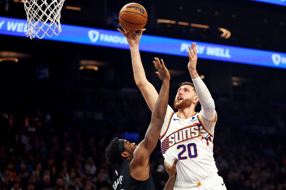 Phoenix Suns center Jusuf Nurkic (20) shoots the ball against Brooklyn Nets center Day'Ron Sharpe (20) during the third quarter at Footprint Center in Phoenix on Dec. 13, 2023.