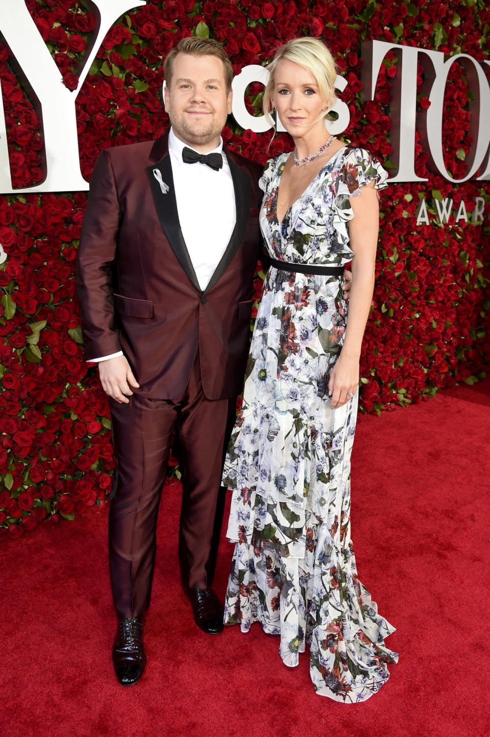 Host James Corden in an ox blood tuxedo with his wife, Julia Carey