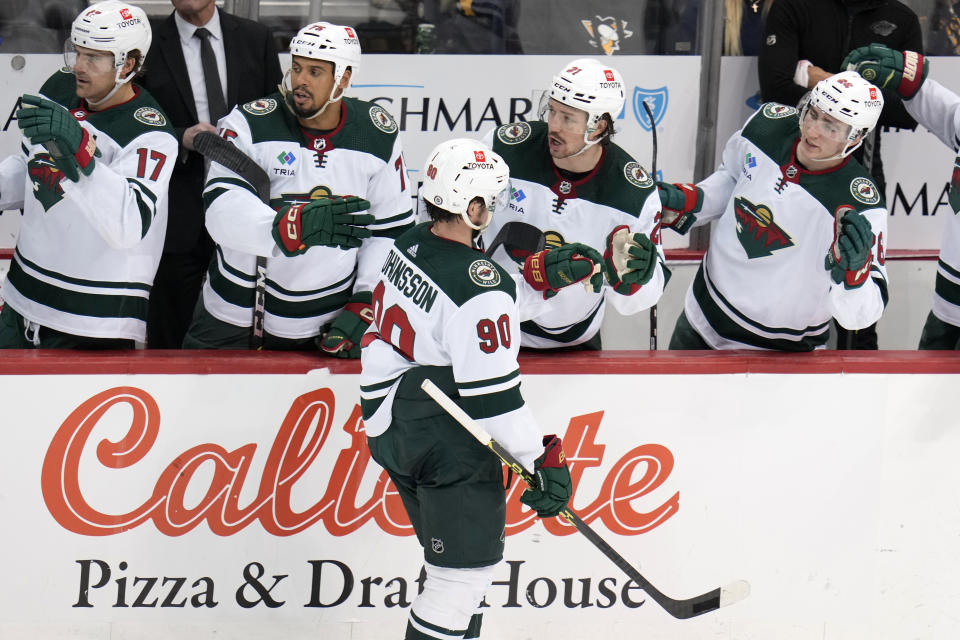 Minnesota Wild's Marcus Johansson (90) returns to the bench after scoring during the third period of an NHL hockey game against the Pittsburgh Penguins in Pittsburgh, Thursday, April 6, 2023. (AP Photo/Gene J. Puskar)