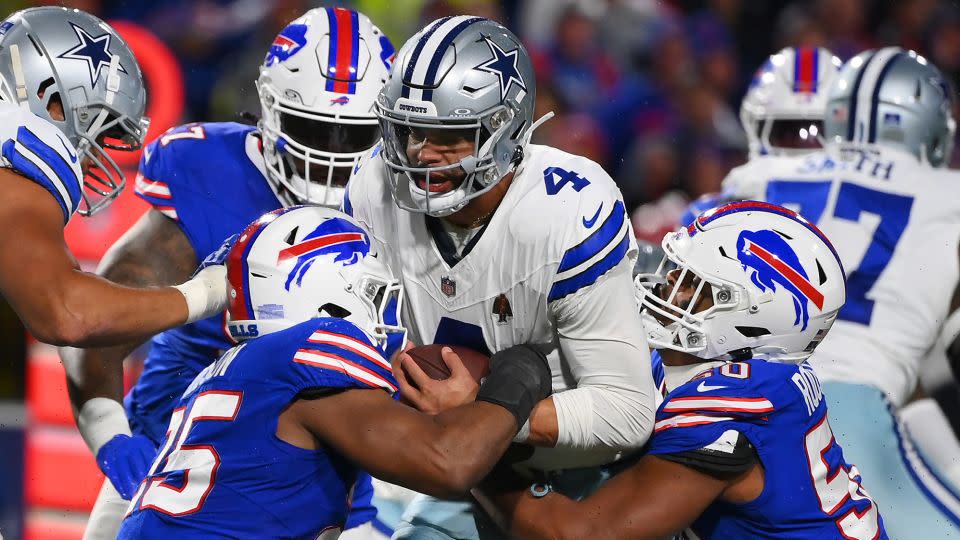 Dak Prescott is sacked by Tyrel Dodson and Greg Rousseau during the third quarter at Highmark Stadium. - Rich Barnes/Getty Images