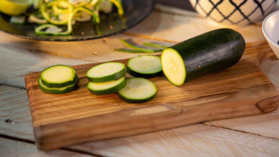 fresh zucchini on wooden cutting board