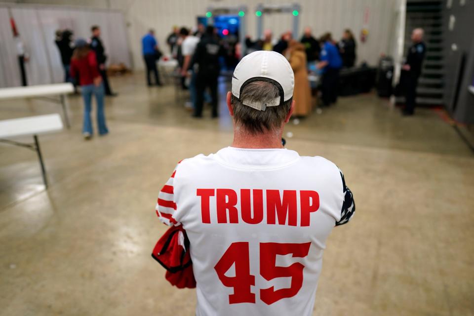 An audience members watches as supporters arrive at a former President Donald Trump commit to caucus rally, Friday, Jan. 5, 2024, in Mason City, Iowa. (AP Photo/Charlie Neibergall)