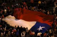 Chilean fans hold a giant national flag as they celebrate Chile's victory over Argentina in their Copa America 2015 final soccer match in Santiago, Chile July 4, 2015. REUTERS/Carlos Garcia Rawlins -