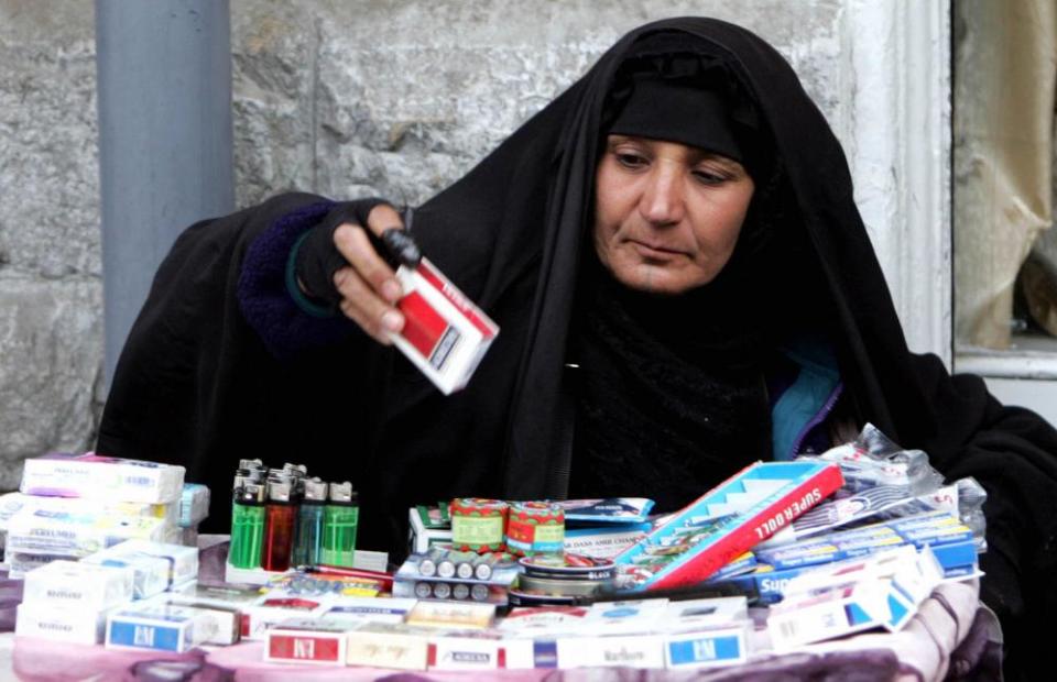 A woman selling cigarettes in Amman.