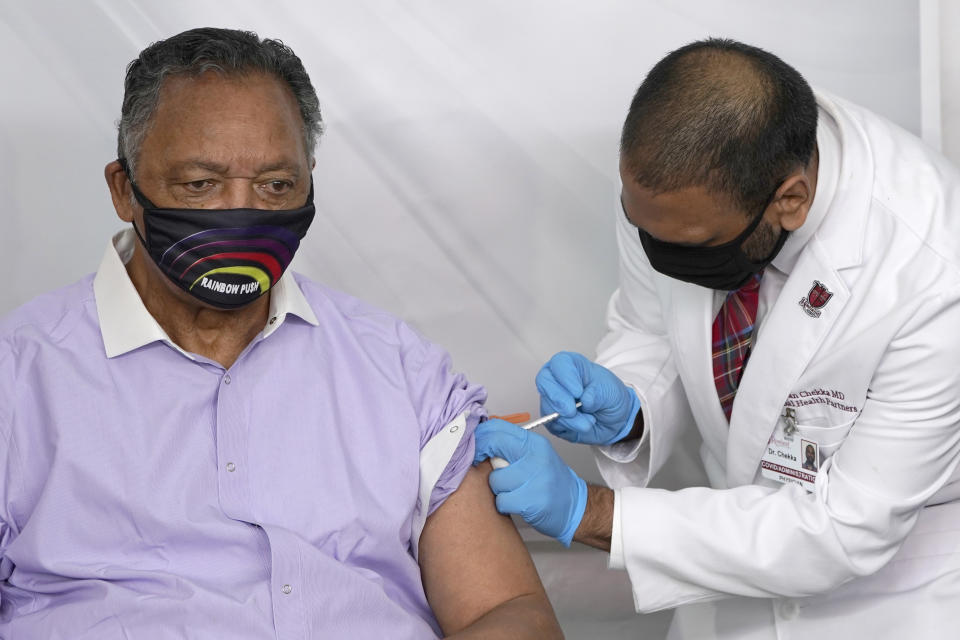 FILE - In this Friday, Jan. 8, 2021 file photo, Rev. Jesse Jackson receives the Pfizer's BioNTech COVID-19 vaccine from Dr. Kiran Chekka, Covid Administration Physician at the Roseland Community Hospital in Chicago. The Rev. Jesse Jackson and his wife, Jacqueline, have been hospitalized after testing positive for COVID-19 according to a statement Saturday, Aug. 21, 2021. He is vaccinated against the virus and publicly received his first dose in January. According to a statement released Saturday evening, the Jacksons are being treated at Northwestern Memorial Hospital in Chicago. He is 79 years old. Jacqueline Jackson is 77. (AP Photo/Charles Rex Arbogast, File)