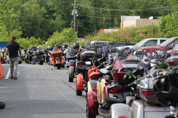 The column of parked motorcycles wrapped all the way around the Asheville Harley-Davidson building.