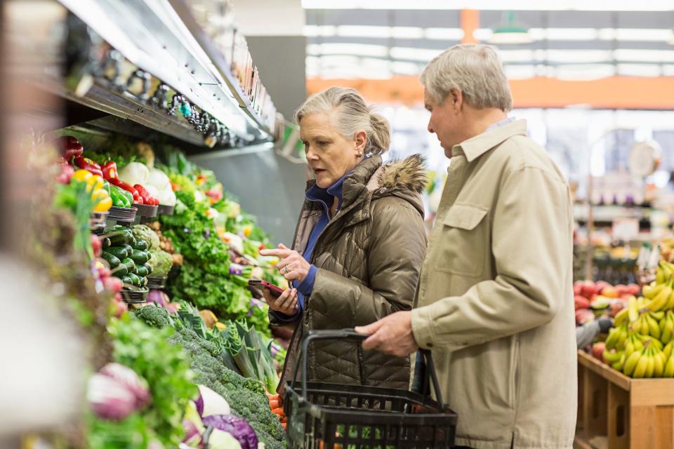 An older couple grocery shopping.