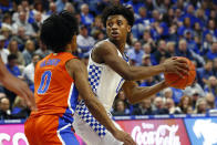 Kentucky's Ashton Hagans, right, looks for an opening on Florida's Ques Glover, left, in the first half of an NCAA college basketball game in Lexington, Ky., Saturday, Feb. 22, 2020. (AP Photo/James Crisp)