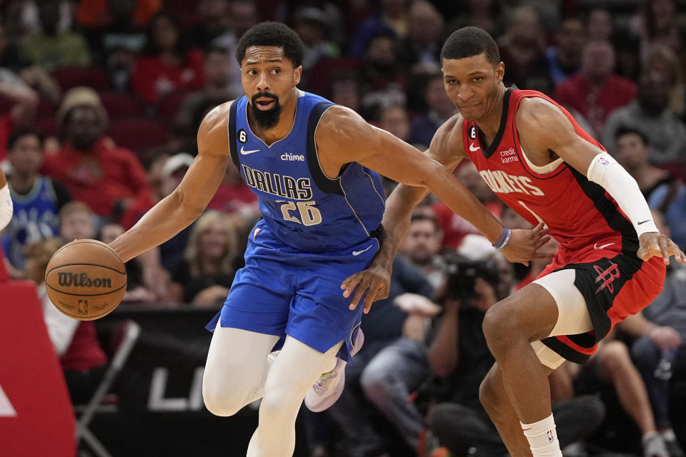 Dallas Mavericks' Spencer Dinwiddie (26) grabs the ball in front of Houston Rockets' Jabari Smith Jr. (1) during the first half of an NBA basketball game Monday, Jan. 2, 2023, in Houston. (AP Photo/David J. Phillip)