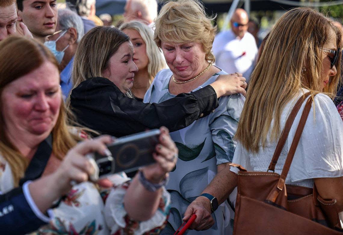 Family members of those who perished on Eastern Flight 401 embrace after the unveiling of the memorial for Eastern Flight 401.