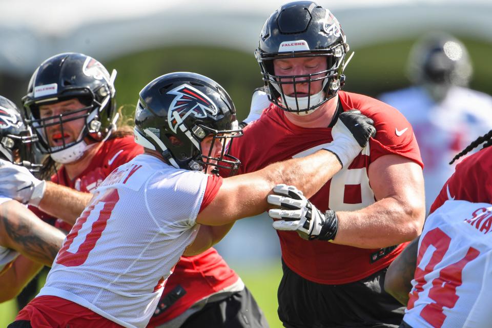 Jul 22, 2019; Flowery Branch, GA, USA; Atlanta Falcons offensive tackle Kaleb McGary (76) (right) blocks defensive end John Cominsky (50) during the first day of training camp at Falcons Training Complex. Mandatory Credit: Dale Zanine-USA TODAY Sports