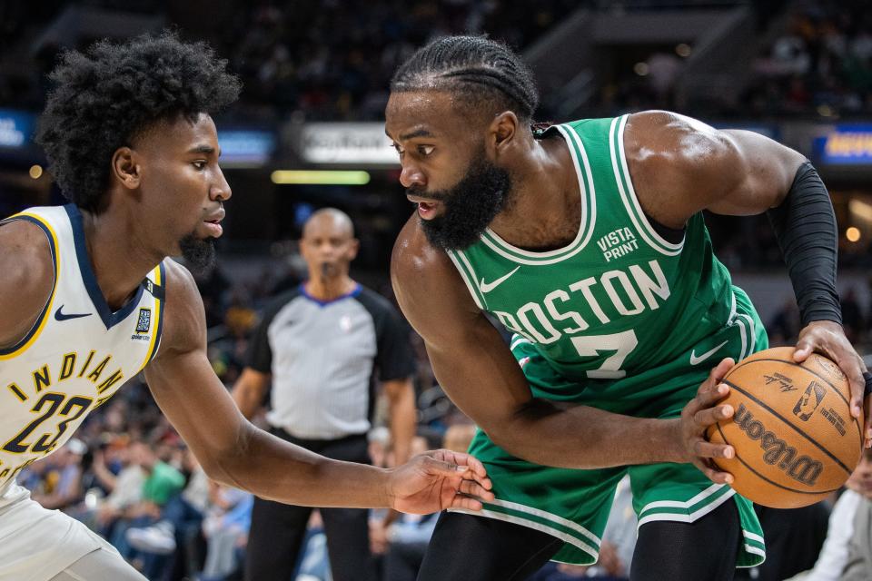 Jan 8, 2024; Indianapolis, Indiana, USA; Boston Celtics guard Jaylen Brown (7) holds the ball while Indiana Pacers forward Aaron Nesmith (23) defends in the first half at Gainbridge Fieldhouse. Mandatory Credit: Trevor Ruszkowski-USA TODAY Sports