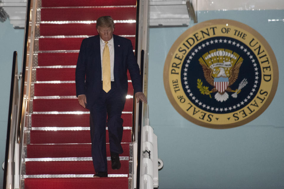 President Donald Trump departs Air Force One early Saturday, Oct. 12, 2019, at Andrews Air Force Base, Md., after returning from a campaign rally in Louisiana. (AP Photo/Kevin Wolf)