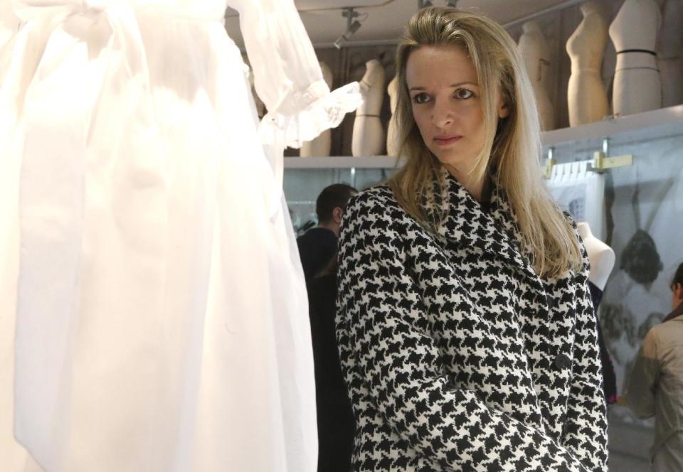 Assistant general manager Christian Dior Couture Delphine Arnault looks a models during a visit of "Particular operation days" in LVMH, the world's largest luxury company at the Fashion House Dior in Paris, Saturday June 15, 2013.(AP Photo/Jacques Brinon)