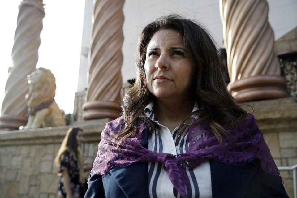 Bibiana Ochoa, of Salt Lake City, a member of La Luz del Mundo church, stands outside one of the church's branches before the start of a service Thursday, June 6, 2019, in Los Angeles. California's top prosecutor said Thursday that he believes there are more victims of child sex abuse than those listed in charges against the leader of Mexico-based megachurch La Luz del Mundo and several followers. (AP Photo/Marcio Jose Sanchez)