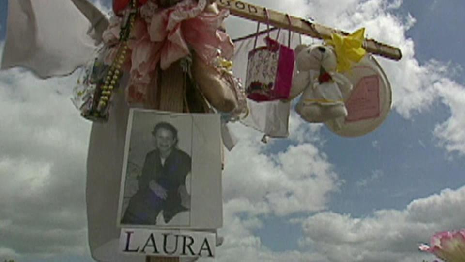 A memorial cross was put up near where Laura Smither's body was found. / Credit: CBS News