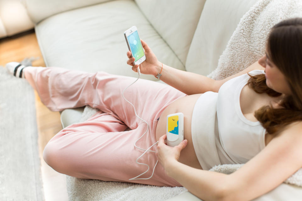 This product image provided by Bellabeat shows the Bellabeat fetal heart listening system. A heart monitor device, available for $129, is plugged into your smartphone's headphone port, then a set of earbuds is plugged into the device. The companion smartphone app tracks the baby’s heart rate and lets you record the sound. (AP Photo/Bellabeat)