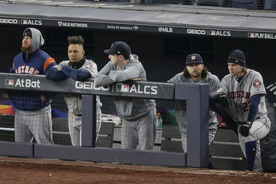 The Houston Astros watch play from the dugout during the ninth inning of Game 5 of baseball's American League Championship Series against the New York Yankees, Friday, Oct. 18, 2019, in New York. The Yankees won 4-1. (AP Photo/Seth Wenig)