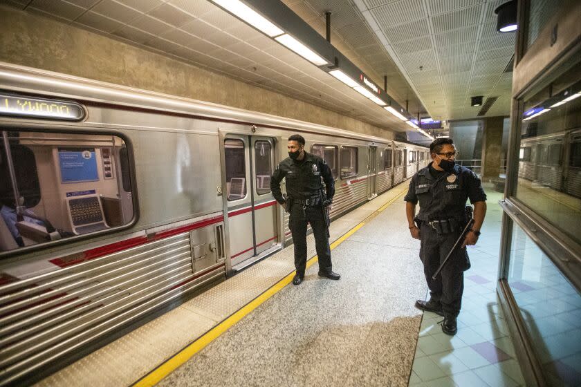 HOLLYWOOD, CA - JUNE 25: LAPD officers E. Rosales, left, and D. Castro, patrol the Metro Red Line at the Hollywood/Highland Metro Station Thursday, June 25, 2020 in Hollywood, CA. The Metro Board of Directors held a meeting Thursday where the agenda included the consideration of appointing a committee to develop plans for replacing armed transit safety officers with ``smarter and more effective methods of providing public safety.'' Metro security is staffed by multiple agencies, including the L.A. County Sheriff's Department and L.A. and Long Beach police departments, transit security guards and contract security workers. (Allen J. Schaben / Los Angeles Times)