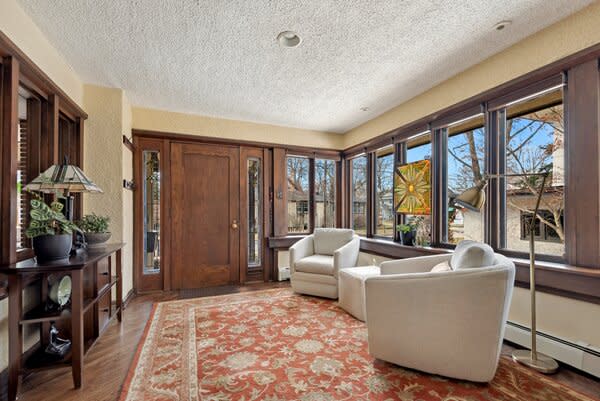 Large, wood-trimmed picture windows span across the main living areas.