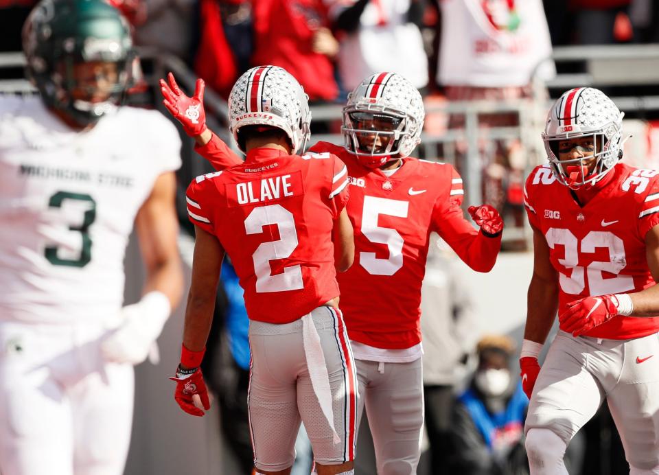 Ohio State wide receiver Chris Olave (2) congratulates wide receiver Garrett Wilson (5) on scoring a touchdown during the second quarter against Michigan State s at Ohio Stadium in Columbus on Saturday, Nov. 20, 2021.