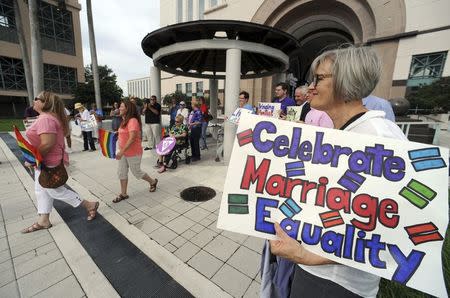 People gathered at the Palm Beach County courthouse to show support for a ruling by a Monroe County judge allowing gay marriage in Monroe County, in West Palm Beach, Florida July 17, 2014. REUTERS/Jim Rassol/Ft. Lauderdale Sun Sentinel