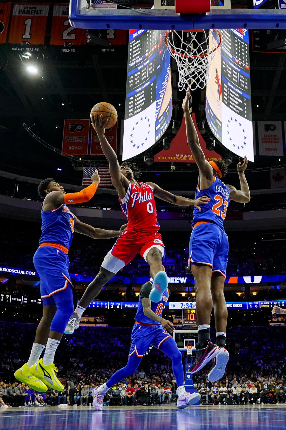 Philadelphia 76ers' Tyrese Maxey, center, shoots against New York Knicks' Mitchell Robinson, right, and R.J. Barrett, left, during the first half of an NBA basketball game Friday, Nov. 4, 2022, in Philadelphia. (AP Photo/Chris Szagola)