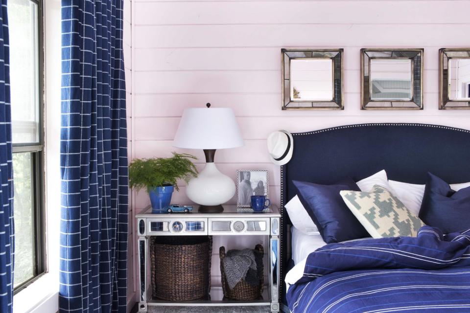 In this photo provided by Brian Patrick Flynn, a guest bedroom by the designer Flynn featured on Hayneedle.com uses a muted shade of blush on the walls and ceiling. Flynn suggests blush tones will become popular in 2014, but to add a fresh touch, they'll be paired with masculine tones such as navy blue. (AP Photo/Hayneedle.com, Sarah Dorio)