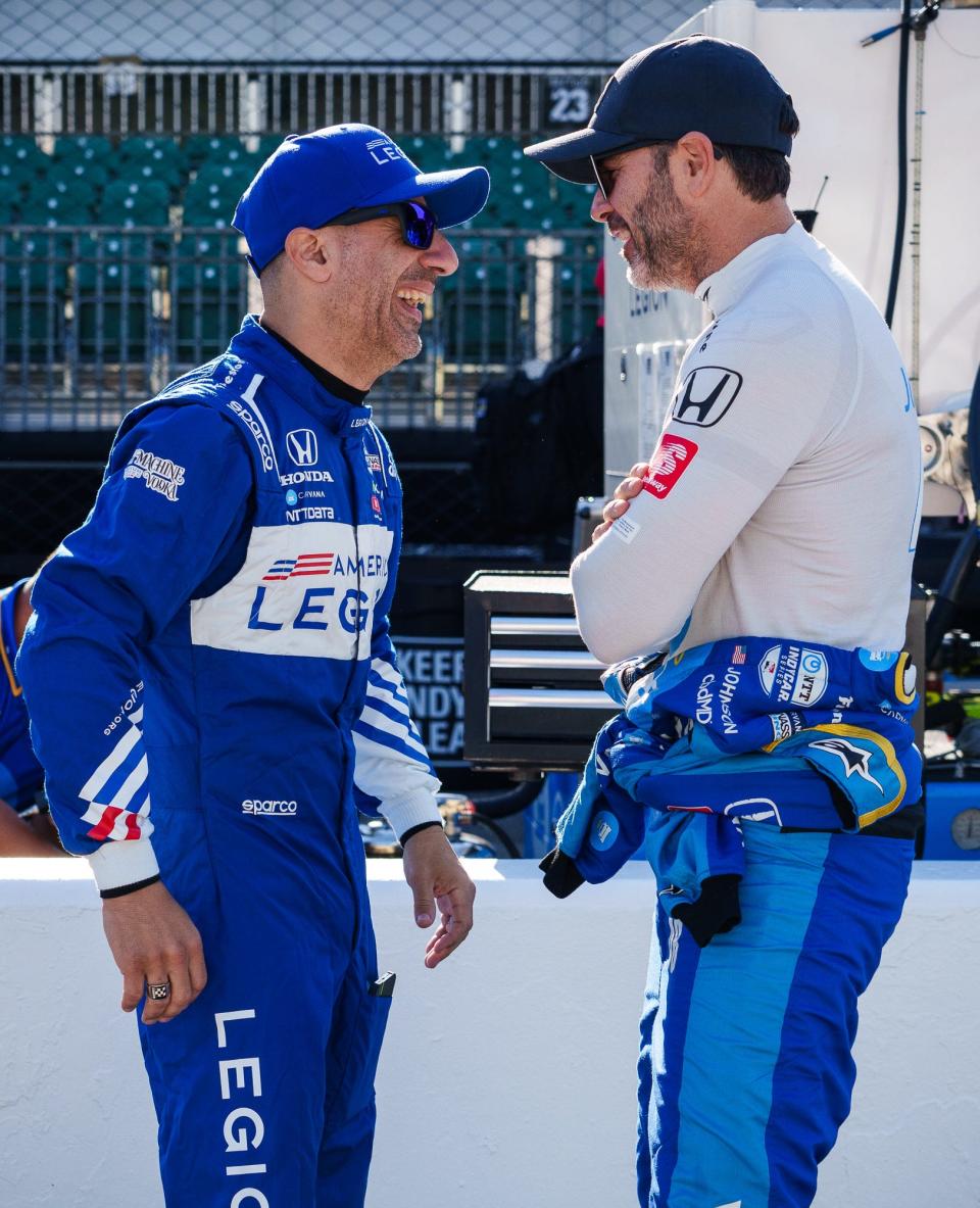 Chip Ganassi Racing driver Tony Kanaan (1) laughs as he greets fellow Ganassi driver Jimmie Johnson (48) on Tuesday, May 17, 2022, ahead of the first practice session in preparation for the 106th running of the Indianapolis 500 at Indianapolis Motor Speedway.