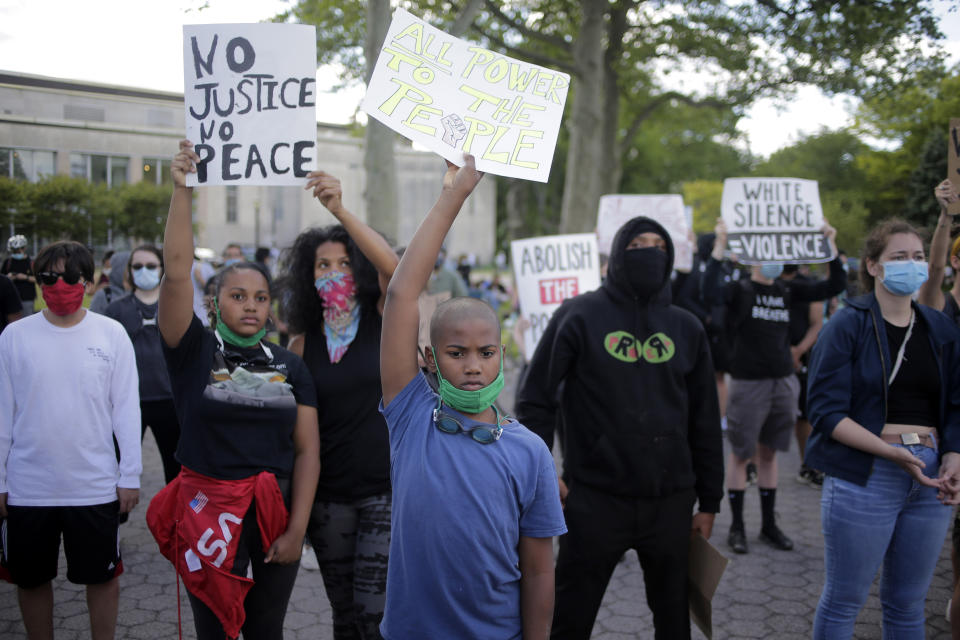 Protesters rally in Flushing Meadows Corona Park in the Queens borough of New York, Sunday, May 31, 2020. Demonstrators took to the streets of New York City to protest the death of George Floyd, a black man who was killed in police custody in Minneapolis on May 25. (AP Photo/Seth Wenig)