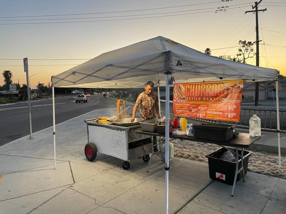 Santiago Juarez fries Oaxacan-style churros in Fresno, California on Monday August 14, 2023. Juarez moved from Los Angeles to Fresno to set up the churro stand because “out there, there’s more competition.”