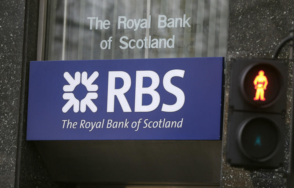 FILE - This is a Friday, Feb. 26, 2016 file photo of a logo of a branch of the Royal Bank of Scotland in London. Royal Bank of Scotland swung to a loss in the second quarter of 2016 as it set aside more cash to cover litigation and conduct issues as it cleans up the problems that led to a taxpayer-funded bailout at the height of the global financial crisis. The now government-controlled bank on Friday Aug. 5, 2016 reported a pretax operating loss of 695 million pounds ($913 million) compared with a profit of 224 million pounds in the same quarter a year earlier (AP Photo/Frank Augstein, File)