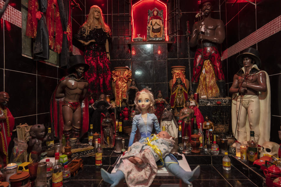 Statues adorn an altar at the Umbanda Spiritual Center Casa de Caridade Santa Barbara e Iansa, in Rio de Janeiro, Brazil, Saturday, Sept. 3, 2022. (AP Photo/Rodrigo Abd)