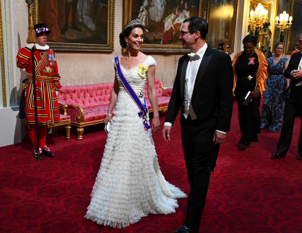 Kate, Duchess of Cambridge and U.S. Treasury Secretary Steven Mnuchin walked into the state banquet through the East Gallery at Buckingham Palace on June 3, 2019. She wore a gown by Alexander McQueen and the Lover's Knot tiara.