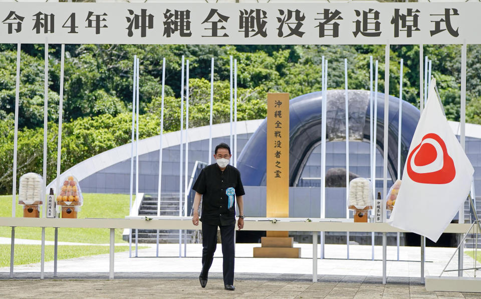 Japan's Prime Minister Fumio Kishida walks off after he offered a bouquet of flowers in front of a memorial at the Peace Memorial Park in Itoman, Okinawa, southern Japan Thursday, June 23, 2022. Japan marked the Battle of Okinawa, one of the bloodiest battles of World War II fought on the southern Japanese island, which ended 77 years ago, Thursday. (Kyodo News via AP)