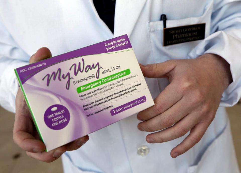 Pharmacist Simon Gorelikov holds a generic emergency contraceptive at the Health First Pharmacy in Boston on May 2, 2013. Some leaders in states that ban abortions at all points of pregnancy say exceptions for rape or incest victims aren’t needed because emergency contraceptives can be used instead. (AP Photo/Elise Amendola, File)