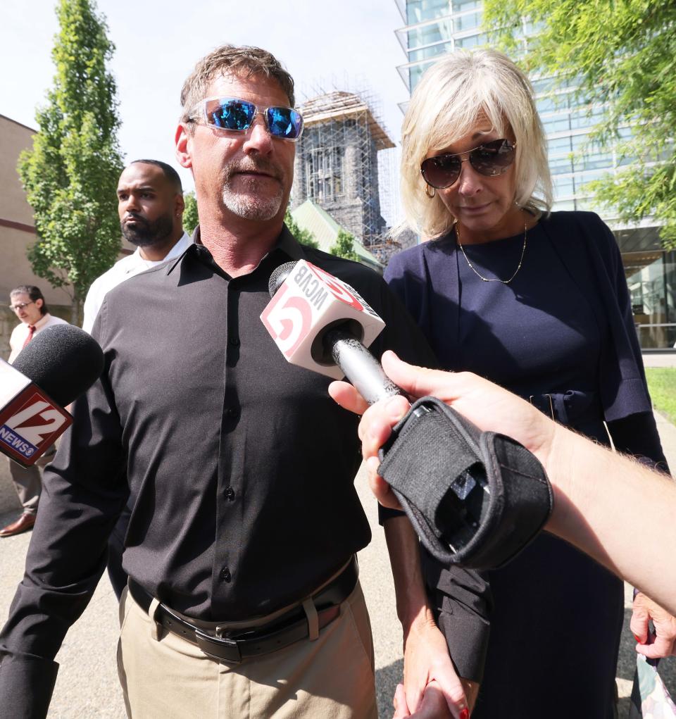 Taunton Mayor Shaunna O'Connell stands alongside her husband Ted as he speaks to the media after the mayor was arraigned in Taunton District Court Monday, July 22, 2024, on charges she attacked her husband with a crowbar during an argument.