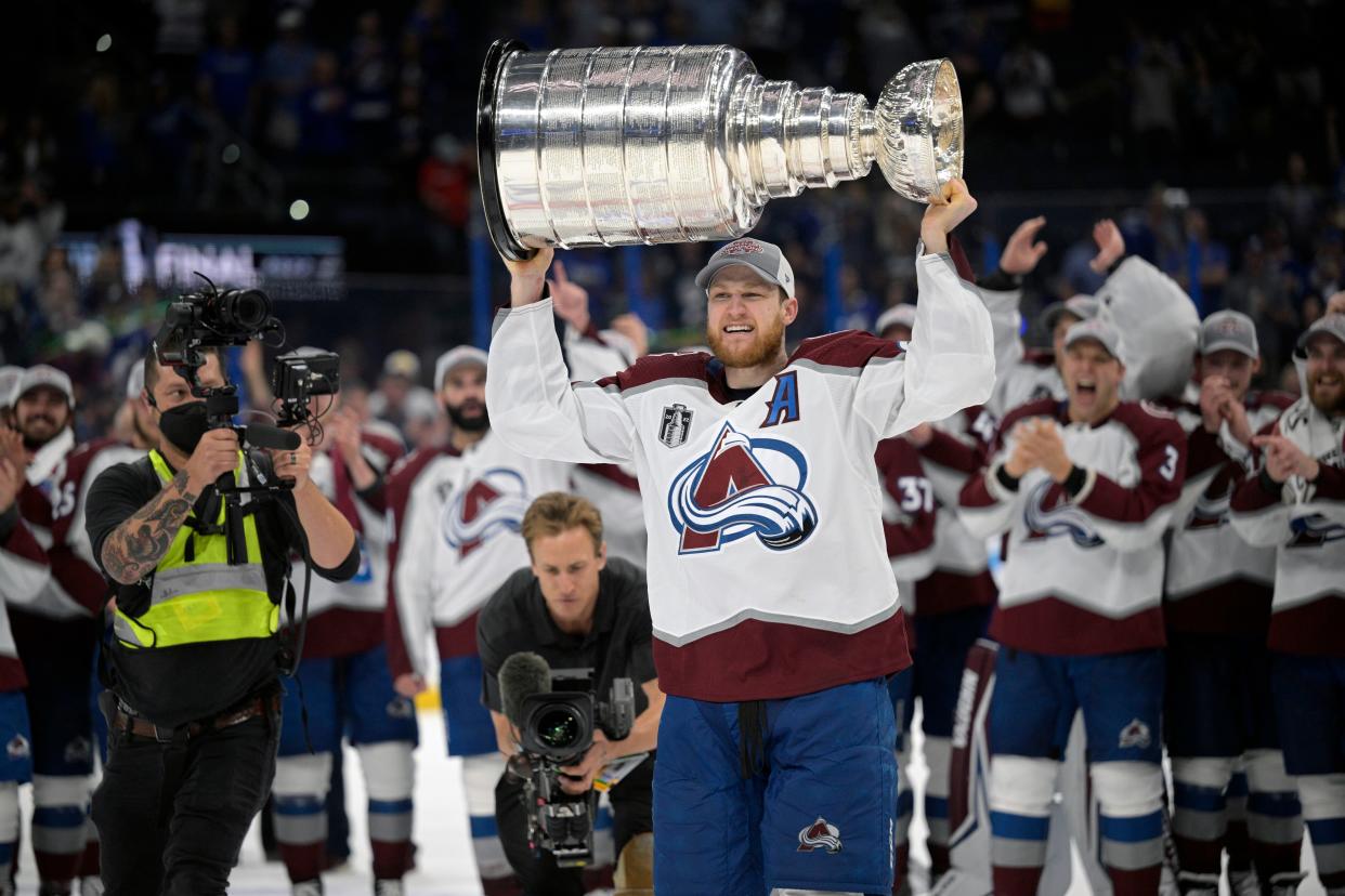 Nathan MacKinnon lifts the Stanley Cup after winning the NHL finals on Sunday night.