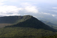 FILE - This Dec. 11, 2016 file photo shows the Virunga National Park, taken from the rim of the crater of the Nyiragongo volcano and looking over the crater of another, extinct volcano, taken in North Kivu Province, Democratic Republic of the Congo. Climate change is increasingly damaging the U.N.’s most cherished heritage sites, a leading conservation agency warned Wednesday Dec. 2, 2020, reporting that Australia’s Great Barrier Reef and dozens of other natural wonders are facing severe threats. (Juergen Baetz/dpa via AP, File)