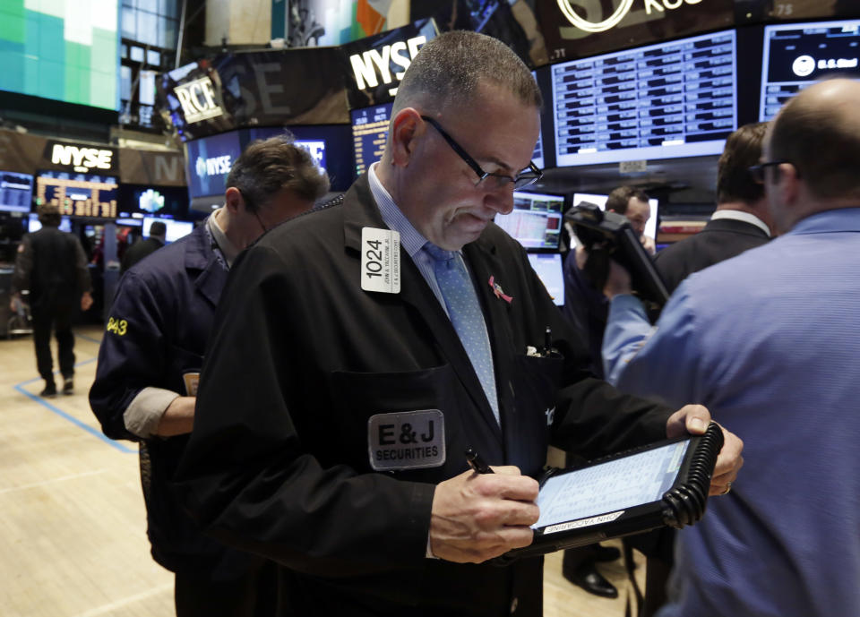 Trader John Yaccarine, center, works on the floor of the New York Stock Exchange Wednesday, March 19, 2014. Stocks are slightly lower in early trading on Wall Street as traders wait for the latest policy decision from the Federal Reserve. (AP Photo/Richard Drew)