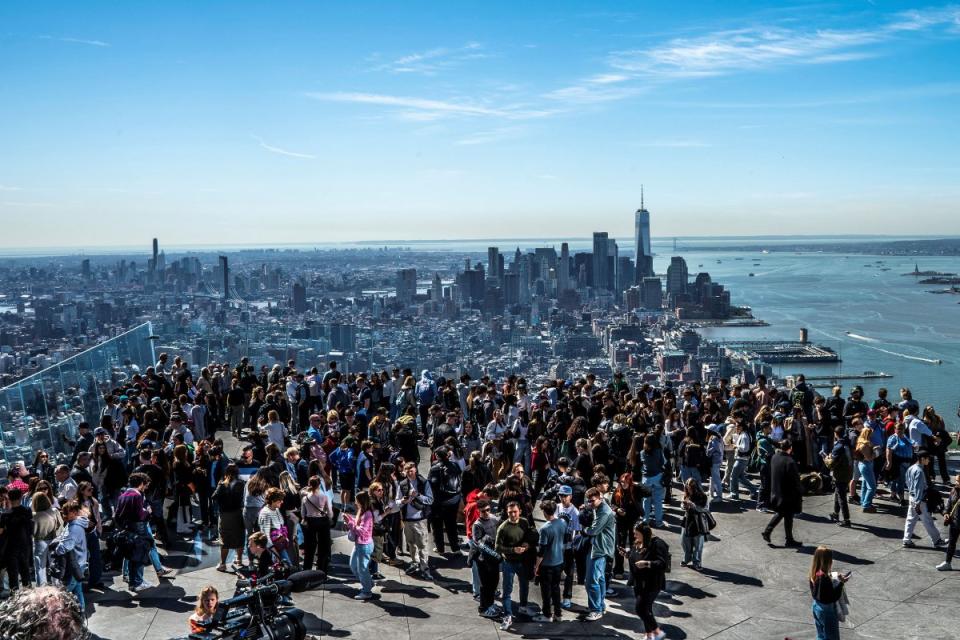 People gather on the observation deck of Edge at Hudson Yards before a partial solar eclipse in New York City.<span class="copyright">Eduardo Munoz—Reuters</span>