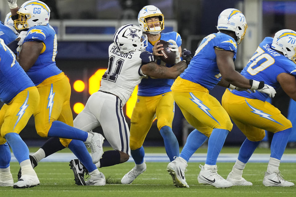 Dallas Cowboys linebacker Micah Parsons (11) sacks Los Angeles Chargers quarterback Justin Herbert, center, during the second half of an NFL football game Monday, Oct. 16, 2023, in Inglewood, Calif. (AP Photo/Mark J. Terrill)