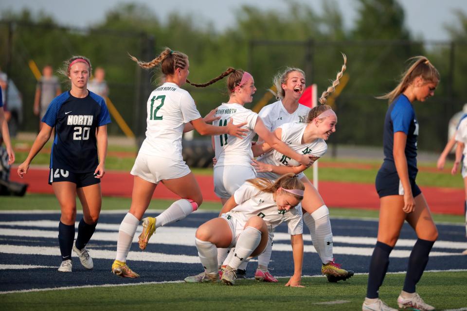 Norman North's Makenna Adam (16), celebrates with teammates, Parker McGraw (12), Rylie Goodman (11), Presslee Amick, top right, and Zoe Walker, bottom, after Adam scored a goal during a girls 6A state tournament semifinal soccer game between Edmond North and Norman North in Edmond, Okla., Tuesday, May 9, 2023. 