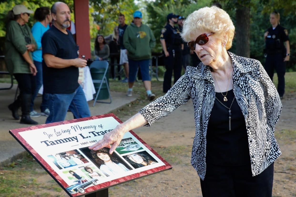 Linda Tracey stands over a plaque dedicated to the memory of her daughter, Tammy Tracey, on Wednesday, Oct. 6, 2021, in Rockford's Searls Park.