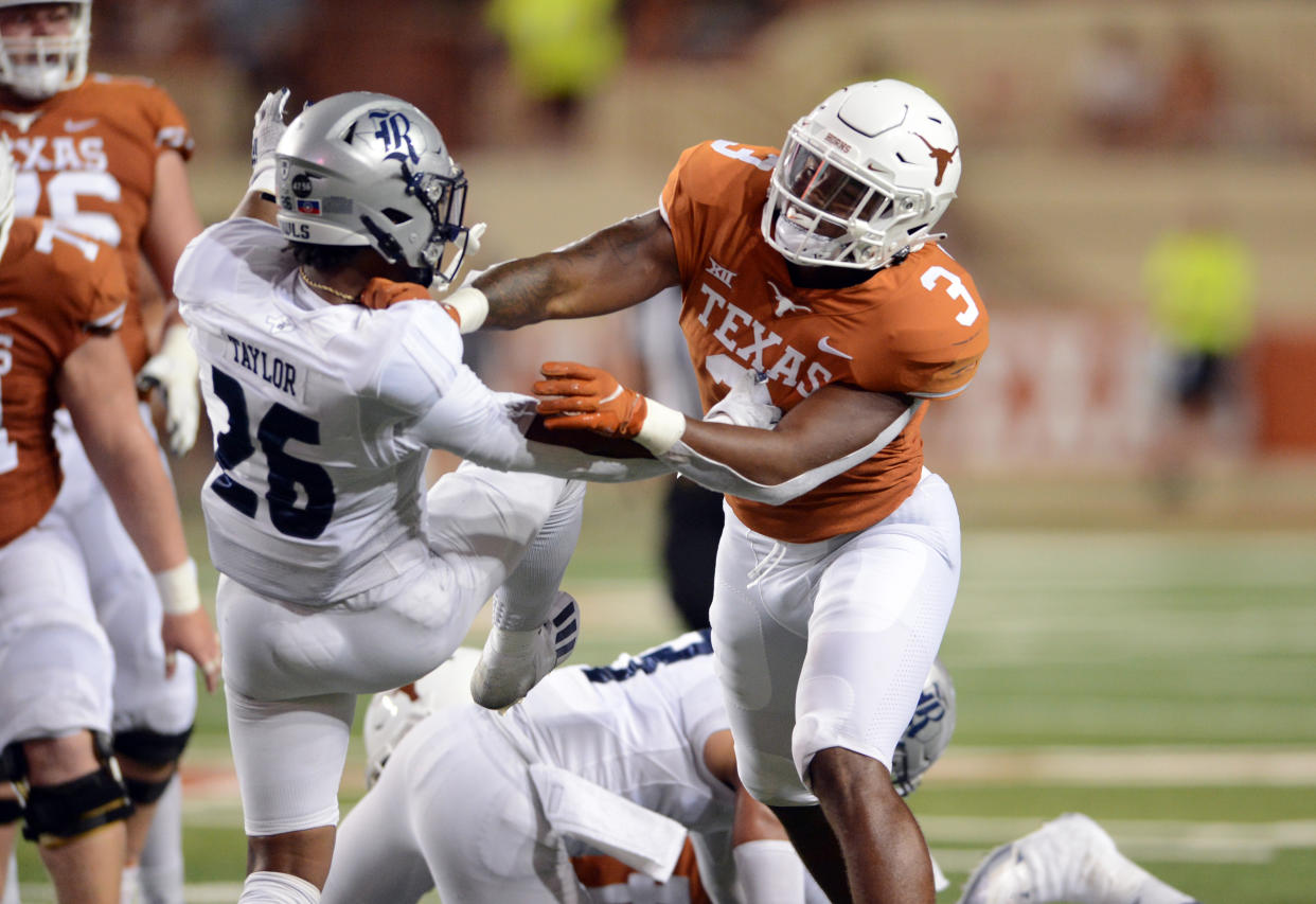 Texas Longhorns TE Ja'Tavion Sanders blocks Rice Owls DB Gabe Taylor.