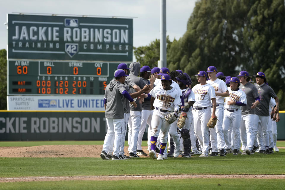 Prairie View A&M University infielder Lee Allen Jr., (2) high fives his teammates after winning a game against North Carolina A&T State University at the Andre Dawson Classic tournament, Friday, Feb. 23, 2024, at the Jackie Robinson Training Complex, in Vero Beach, Fla. The percentage of Black major league players has been declining for decades and remains historically low, but there are signs of improvement in the league's player development pipeline. (AP Photo/Lynne Sladky)