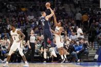 Dallas Mavericks center Kristaps Porzingis (6) shoots over New Orleans Pelicans guard Trey Murphy III (25) in the first half of an NBA basketball game in Dallas, Monday, Nov. 8, 2021. (AP Photo/Tony Gutierrez)